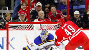 Jan 30, 2015; Raleigh, NC, USA; St. Louis Blues goalie Jake Allen (34) stops the shot by the Carolina Hurricanes forward Victor Rask (49) in the shootout at PNC Arena. The St. Louis Blues defeated the Carolina Hurricanes 3-2 in a shoot out. Mandatory Credit: James Guillory-USA TODAY Sports