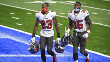 DETROIT, MICHIGAN - DECEMBER 26: Sean Murphy-Bunting #23 of the Tampa Bay Buccaneers and Jamel Dean #35 of the Tampa Bay Buccaneers run off the field after the game against the Detroit Lions at Ford Field on December 26, 2020 in Detroit, Michigan. (Photo by Nic Antaya/Getty Images)