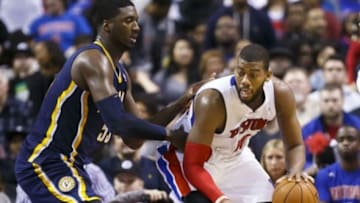 Mar 15, 2014; Auburn Hills, MI, USA; Detroit Pistons forward Greg Monroe (10) is defended by Indiana Pacers center Roy Hibbert (55) in the fourth quarter at The Palace of Auburn Hills. Indiana won in overtime 112-104. Mandatory Credit: Rick Osentoski-USA TODAY Sports