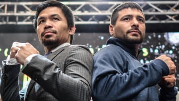TOPSHOT - Filipino boxing idol Manny Pacquiao (centre L) poses for photographs with Argentina's Lucas Matthysse (centre R) after a press conference in Kuala Lumpur on April 20, 2018, ahead of their world welterweight boxing championship bout in July. (Photo by Mohd RASFAN / AFP) (Photo credit should read MOHD RASFAN/AFP/Getty Images)