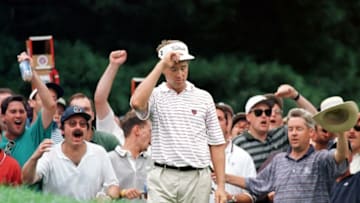MAMARONECK, UNITED STATES: Davis Love III of the US tips his hat as the crowd goes wild after his chip shot to the 12th green 17 August during the final round of the PGA Championship at Winged Foot. Love won the championship, finishing 11-under-par. AFP PHOTO/Jon LEVY (Photo credit should read JON LEVY/AFP via Getty Images)