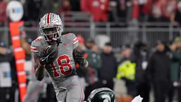 Nov. 11, 2023; Columbus, Oh., USA;Ohio State Buckeyes wide receiver Marvin Harrison Jr. (18) is tripped up by Michigan State Spartans defensive back Ade Willie (20) during Saturday's NCAA Division I football game at Ohio Stadium.