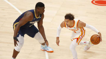 Trae Young #11 of the Atlanta Hawks battles Zion Williamson #1 of the New Orleans Pelicans (Photo by Todd Kirkland/Getty Images)