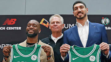 BOSTON - JULY 17: New Boston Celtics point guard Kemba Walker, left, and center Enes Kanter, right, stand with Celtics president Danny Ainge during an introductory press conference at the Auerbach Center in the Brighton neighborhood of Boston on July 17, 2019. (Photo by Jim Davis/The Boston Globe via Getty Images)