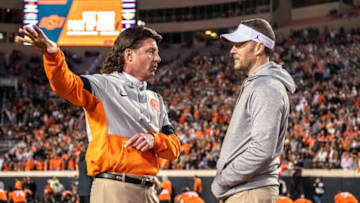 Nov 30, 2019; Stillwater, OK, USA; Oklahoma State Cowboys head coach Mike Gundy (left) and Oklahoma Sooners head coach Lincoln Riley (right) meet before a game at Boone Pickens Stadium. Mandatory Credit: Rob Ferguson-USA TODAY Sports