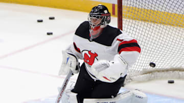 UNIONDALE, NEW YORK - JANUARY 21: Eric Comrie #1 of the New Jersey Devils skates in warm-ups prior to the game against the New York Islanders at Nassau Coliseum on January 21, 2021 in Uniondale, New York. (Photo by Bruce Bennett/Getty Images)