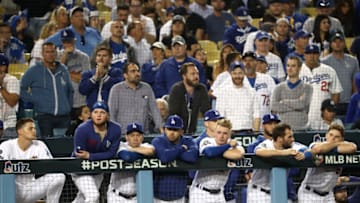 LOS ANGELES, CALIFORNIA - OCTOBER 09: The Los Angeles Dodgers look on from the dug out as they lose to the Washington Nationals 7-3 in ten innings of game five and the National League Division Series at Dodger Stadium on October 09, 2019 in Los Angeles, California. (Photo by Sean M. Haffey/Getty Images)