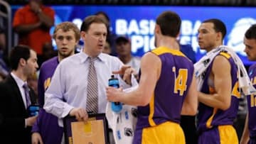 Mar 20, 2014; Orlando, FL, USA; Albany Great Danes head coach Will Brown huddles up against the Florida Gators during the second half of a men