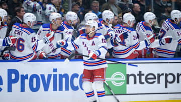 VANCOUVER, CANADA - OCTOBER 28: Artemi Panarin #10 of the New York Rangers is congratulated at the players bench after scoring a goal against the Vancouver Canucks during the first period of their NHL game at Rogers Arena on October 28, 2023 in Vancouver, British Columbia, Canada. (Photo by Derek Cain/Getty Images)