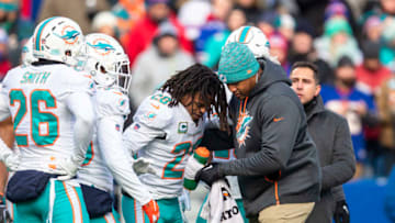 ORCHARD PARK, NY - DECEMBER 30: Bobby McCain #28 of the Miami Dolphins is attended to by trainers following a scuffle between both teams during the third quarter against the Buffalo Bills at New Era Field on December 30, 2018 in Orchard Park, New York. Buffalo defeats Miami 42-17. (Photo by Brett Carlsen/Getty Images)