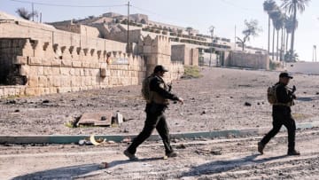Iraqi forces patrol the front of the Nabi Yunus shrine in Mosul. Image credit: DIMITAR DILKOFF/Getty