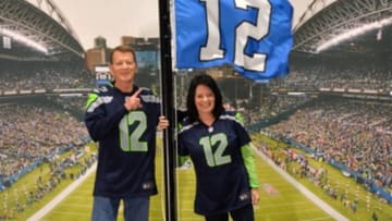Nov 15, 2015; Seattle, WA, USA; Seattle Seahawks fans pose with the 12th man flag prior to a NFL football game against the Arizona Cardinals at CenturyLink Field. Mandatory Credit: Kirby Lee-USA TODAY Sports