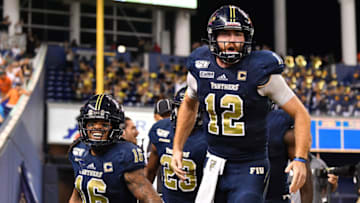 MIAMI, FLORIDA - NOVEMBER 23: (L-R) Tony Gaiter IV #16, James Morgan #12, and Austin Maloney #15 of the FIU Golden Panthers celebrate a touchdown against the Miami Hurricanes in the fourth quarter at Marlins Park on November 23, 2019 in Miami, Florida. (Photo by Mark Brown/Getty Images)