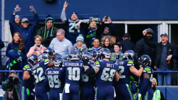 SEATTLE, WA - DECEMBER 31: The Seattle Seahawks swarm Tyler Lockett