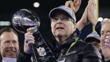 EAST RUTHERFORD, NJ - FEBRUARY 02: Team owner Paul Allen of the Seattle Seahawks celebrates with the Vince Lombardi trophy after defeating the Denver Broncos 43-8 in Super Bowl XLVIII at MetLife Stadium on February 2, 2014 in East Rutherford, New Jersey. (Photo by Kevin C. Cox/Getty Images)