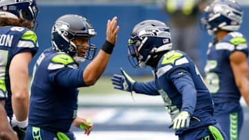 Dec 13, 2020; Seattle, Washington, USA; Seattle Seahawks quarterback Russell Wilson (3) celebrates with wide receiver Freddie Swain (18) after throwing a touchdown pass to Swain against the New York Jets during the first quarter at Lumen Field. Mandatory Credit: Joe Nicholson-USA TODAY Sports