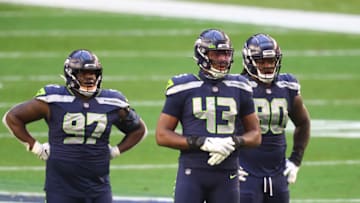 Jan 3, 2021; Glendale, Arizona, USA; Seattle Seahawks defensive tackle Poona Ford (97), defensive end Carlos Dunlap (43) and defensive tackle Jarran Reed (90) against the San Francisco 49ers at State Farm Stadium. Mandatory Credit: Mark J. Rebilas-USA TODAY Sports