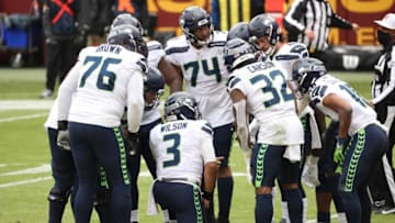 Dec 20, 2020; Landover, Maryland, USA; Seattle Seahawks quarterback Russell Wilson (3) huddles with teammates against the Washington Football Team at FedExField. Mandatory Credit: Geoff Burke-USA TODAY Sports
