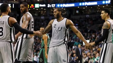 Nov 25, 2016; Boston, MA, USA; San Antonio Spurs forward Kawhi Leonard (2) is congratulated after a basket by guard Patty Mills (8) and guard Danny Green (14) during the second half of the San Antonio Spurs 109-103 win over the Boston Celtics at TD Garden. Mandatory Credit: Winslow Townson-USA TODAY Sports
