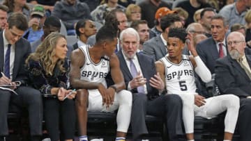 SAN ANTONIO, TX - FEBRUARY 26: Head coach of the San Antonio Spurs Gregg Popovich talks with Lonnie Walker #1 and Dejounte Murray #5 during first half action at AT&T Center (Photo by Ronald Cortes/Getty Images)
