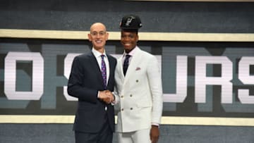 BROOKLYN, NY - JUNE 21: Lonnie Walker IV shakes hands with NBA Commissioner Adam Silver after being selected number eighteen overall by the San Antonio Spurs during the 2018 NBA Draft on June 21, 2018 at Barclays Center in Brooklyn, New York. NOTE TO USER: User expressly acknowledges and agrees that, by downloading and or using this photograph, User is consenting to the terms and conditions of the Getty Images License Agreement. Mandatory Copyright Notice: Copyright 2018 NBAE (Photo by Jesse D. Garrabrant/NBAE via Getty Images)