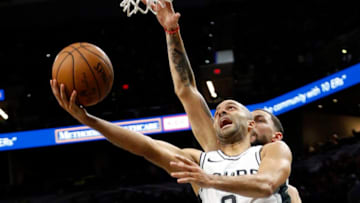 SAN ANTONIO,TX - DECEMBER 18 : Tony Parker #9 of the San Antonio Spurs scores in front of Austin Rivers #25 of the Los Angeles Clippers at AT&T Center on December 18, 2017 in San Antonio, Texas. NOTE TO USER: User expressly acknowledges and agrees that , by downloading and or using this photograph, User is consenting to the terms and conditions of the Getty Images License Agreement. (Photo by Ronald Cortes/Getty Images)