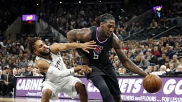 SAN ANTONIO,TX - DECEMBER 18 : Patty Mills #8 of the San Antonio Spurs tries to guard Montrezl Harrell #5 of the Los Angeles Clippers at AT&T Center on December 18, 2017 in San Antonio, Texas. NOTE TO USER: User expressly acknowledges and agrees that , by downloading and or using this photograph, User is consenting to the terms and conditions of the Getty Images License Agreement. (Photo by Ronald Cortes/Getty Images)