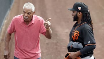 Feb 18, 2016; Scottsdale, AZ, USA; San Francisco Giants former player Felipe Alou (L) talks to pitcher Johnny Cueto (47) during spring training camp at Scottsdale Stadium. Mandatory Credit: Rick Scuteri-USA TODAY Sports