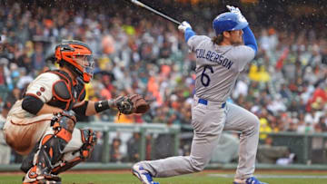 Apr 9, 2016; San Francisco, CA, USA; Los Angeles Dodgers second baseman Charlie Culberson (6) hits the game-winning RBI double in front of San Francisco Giants catcher Buster Posey (28) during the tenth inning at AT&T Park. Mandatory Credit: Kenny Karst-USA TODAY Sports