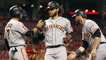 May 2, 2016; Cincinnati, OH, USA; San Francisco Giants shortstop Brandon Crawford (middle) is congratulated by outfielder Gregor Blanco (left) and first baseman Brandon Belt (right) after Crawford hit a three- run home run against the Cincinnati Reds during the seventh inning at Great American Ball Park. The Giants won 9-6. Mandatory Credit: David Kohl-USA TODAY Sports