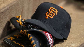 Jul 31, 2015; Arlington, TX, USA; A view of a San Francisco Giants baseball hat and glove during the game between the Texas Rangers and the San Francisco Giants at Globe Life Park in Arlington. The Rangers defeated the Giants 6-3. Mandatory Credit: Jerome Miron-USA TODAY Sports