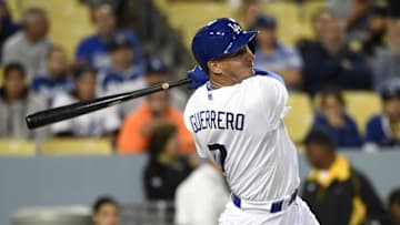 May 27, 2015; Los Angeles, CA, USA; Los Angeles Dodgers left fielder Alex Guerrero (7) hits a solo home run against the Atlanta Braves during the ninth inning of the game at Dodger Stadium. Mandatory Credit: Richard Mackson-USA TODAY Sports
