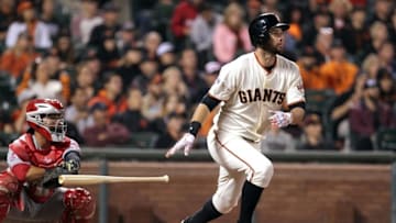 Sep 14, 2015; San Francisco, CA, USA; San Francisco Giants first baseman Brandon Belt (9) hits a RBI triple in the third inning of their MLB baseball game with the Cincinnati Reds at AT&T Park. Mandatory Credit: Lance Iversen-USA TODAY Sports