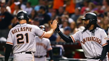 Jul 1, 2016; Phoenix, AZ, USA; San Francisco Giants third baseman Conor Gillaspie (21) celebrates with pitcher Johnny Cueto after scoring in the sixth inning against the Arizona Diamondbacks at Chase Field. Mandatory Credit: Mark J. Rebilas-USA TODAY Sports