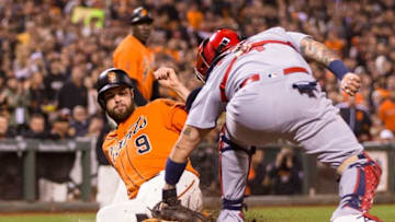 Sep 16, 2016; San Francisco, CA, USA; San Francisco Giants first baseman Brandon Belt (9) slides in safely as St. Louis Cardinals catcher Yadier Molina (4) applies a tag on a contested play in which was ruled in favor of the Giants in the third inning at AT&T Park. Mandatory Credit: John Hefti-USA TODAY Sports