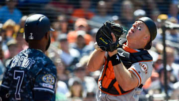 SAN DIEGO, CA - MARCH 31: Erik Kratz #5 of the San Francisco Giants drops a foul ball hit by Fernando Tatis Jr. #23 of the San Diego Padres as Manuel Margot #7 looks on during the fourth inning of a baseball game at Petco Park March 31, 2019 in San Diego, California. (Photo by Denis Poroy/Getty Images)