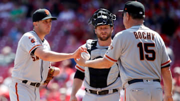 CINCINNATI, OH - MAY 06: Pat Venditte #43 of the San Francisco Giants hands the ball to manager Bruce Bochy during a pitching change in the sixth inning against the Cincinnati Reds at Great American Ball Park on May 6, 2019 in Cincinnati, Ohio. The Reds won 12-4. (Photo by Joe Robbins/Getty Images)
