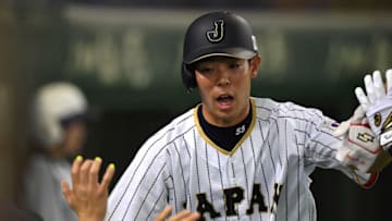 TOKYO, JAPAN - NOVEMBER 12: Shogo Akiyama #55 of Japan celebrates after returning to home base by a RBI grounder by Sho Nakata #13 of Japan in the first inning during the international friendly match between Japan and Netherlands at the Tokyo Dome on November 12, 2016 in Tokyo, Japan. (Photo by Masterpress/Getty Images)