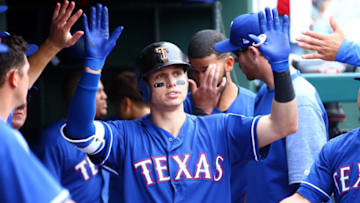 ARLINGTON, TX - APRIL 01: Drew Robinson #18 of the Texas Rangers is congratulated for hitting a hits a solo home run home run in the eighth inning against the Houston Astros at Globe Life Park in Arlington on April 1, 2018 in Arlington, Texas. (Photo by Rick Yeatts/Getty Images)