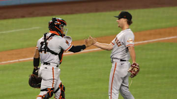 LOS ANGELES, CALIFORNIA - AUGUST 08: Chadwick Tromp #14 and Trevor Gott #58 of the San Francisco Giants celebrate their 5-4 win over the Los Angeles Dodgers at Dodger Stadium on August 08, 2020 in Los Angeles, California. (Photo by Katelyn Mulcahy/Getty Images)