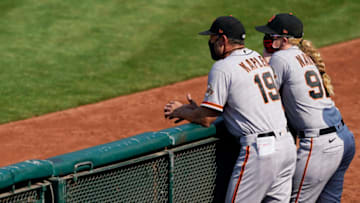 OAKLAND, CALIFORNIA - SEPTEMBER 20: Manager Gabe Kapler #19 and assistant coach Alyssa Nakken #92 of the San Francisco Giants looks on against the Oakland Athletics in the top of the six inning at RingCentral Coliseum on September 20, 2020 in Oakland, California. (Photo by Thearon W. Henderson/Getty Images)