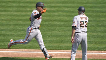 OAKLAND, CALIFORNIA - SEPTEMBER 20: Chadwick Tromp #14 of the SF Giants is congratulated by third base coach Ron Wotus #23 after Tromp hits a two-run home run against the Oakland Athletics in the top of the third inning at RingCentral Coliseum on September 20, 2020 in Oakland, California. (Photo by Thearon W. Henderson/Getty Images)