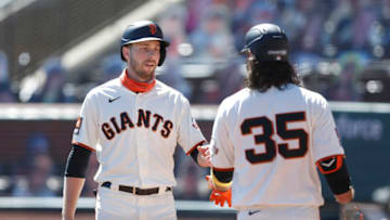 SAN FRANCISCO, CALIFORNIA - SEPTEMBER 24: Austin Slater #13 of the San Francisco Giants celebrates with Brandon Crawford #35 after scoring on a single by Wilmer Flores #41 in the bottom of the first inning against the Colorado Rockies at Oracle Park on September 24, 2020 in San Francisco, California. (Photo by Lachlan Cunningham/Getty Images)