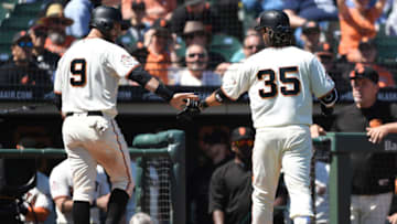 SAN FRANCISCO, CA - MAY 02: Brandon Belt #9 and Brandon Crawford #35 of the San Francisco Giants slap hands after Crawford's sacrifice fly scoring Belt against the San Diego Padres in the bottom of the sixth inning at AT&T Park on May 2, 2018 in San Francisco, California. The Giants won the game 9-4. (Photo by Thearon W. Henderson/Getty Images)
