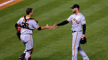 DENVER, CO - MAY 30: Relief pitcher Hunter Strickland #60 and Buster Posey #28 celebrate their 7-4 victory against the Colorado Rockies at Coors Field on May 30, 2018 in Denver, Colorado. (Photo by Justin Edmonds/Getty Images)