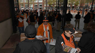 SAN FRANCISCO, CA - APRIL 10: Fan enter the ball park and receive calendars prior to the start of a major league baseball game between the Arizona Diamondbacks and San Francisco Giants on opening day at AT
