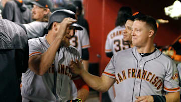PHOENIX, AZ - SEPTEMBER 25: Hunter Pence #8 of the San Francisco Giants (L) is congratulated by teammate Nick Hundley #5 after hitting a solo home run against the Arizona Diamondbacks during the fourth inning of a MLB game at Chase Field on September 25, 2017 in Phoenix, Arizona. (Photo by Ralph Freso/Getty Images)