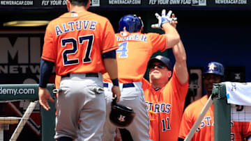 KANSAS CITY, MO - MAY 28: George Springer #4 of the Houston Astros is congratulated by hitting coach John Mallee #11 after hitting a two-run home run during the 1st inning of the game against the Kansas City Royals at Kauffman Stadium on May 28, 2014 in Kansas City, Missouri. (Photo by Jamie Squire/Getty Images)