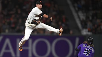 SAN FRANCISCO, CA - SEPTEMBER 19: Joe Panik #12 of the San Francisco Giants completes the double-play with a leaping throw over the top of Charlie Blackmon #19 of the Colorado Rockies in the top of the fifth inning at AT&T Park on September 19, 2017 in San Francisco, California. (Photo by Thearon W. Henderson/Getty Images)