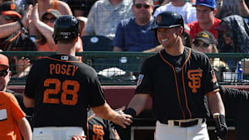 SCOTTSDALE, AZ - MARCH 09: Buster Posey #28 of the San Francisco Giants is congratuled by Joe Panik #12 after scoring against the Seattle Mariners in the fourth inning of the spring training game at Scottsdale Stadium on March 9, 2018 in Scottsdale, Arizona. (Photo by Jennifer Stewart/Getty Images)